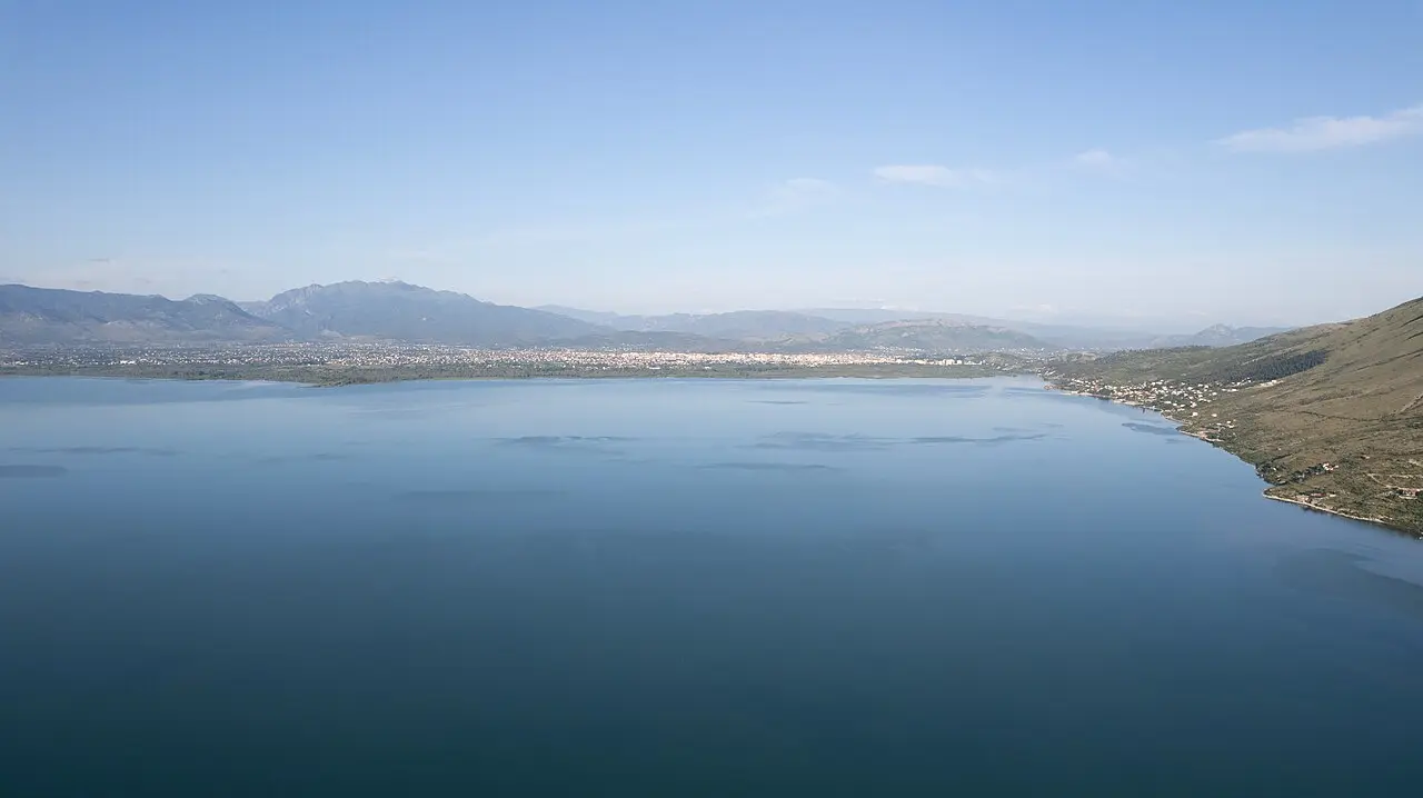 Lake Shkodra with the city and the Albanian Alps behind it, seen from above